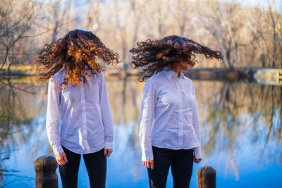 Rear view of women standing in water