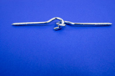 High angle view of chain on blue background