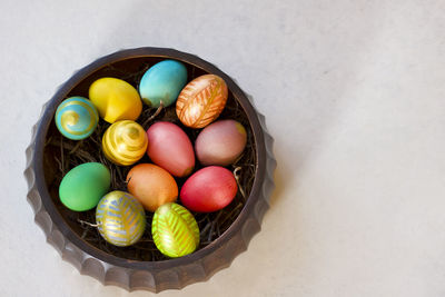High angle view of multi colored eggs in basket