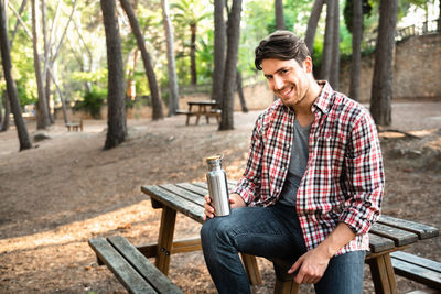 Portrait of a smiling young man sitting outdoors