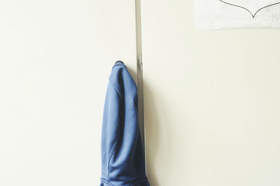 Close-up of clothes hanging on white wall