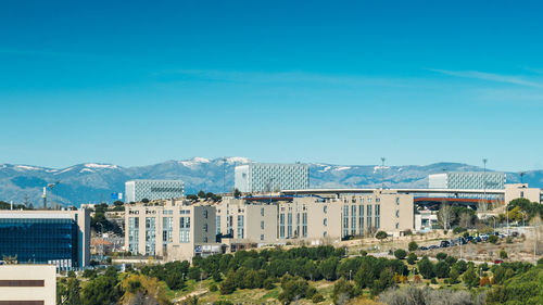 Buildings in city against blue sky