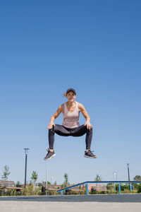 Portrait of woman against clear blue sky