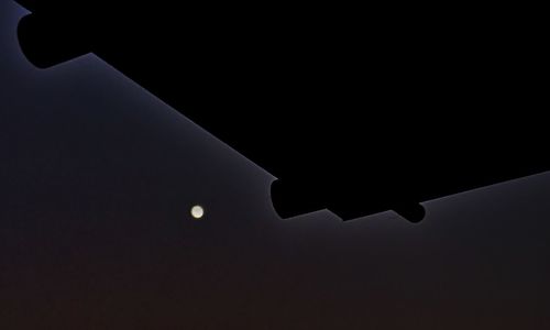 Low angle view of silhouette moon at night