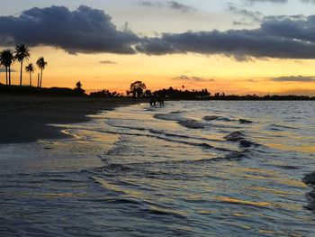 Scenic view of beach against sky during sunset