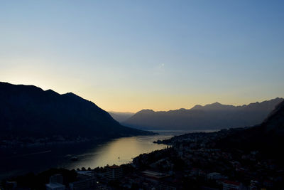 Scenic view of silhouette mountains against clear sky during sunset