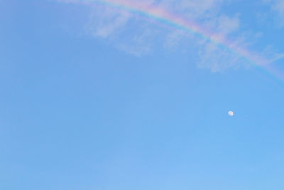 Low angle view of moon against blue sky