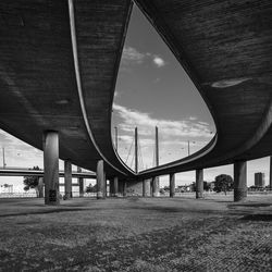 Low angle view of bridge against cloudy sky