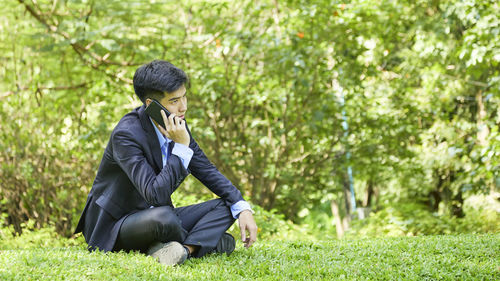 Young man sitting on grass
