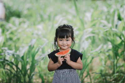 Portrait of smiling girl holding watermelon