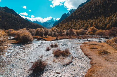 Scenic view of river amidst valley against sky