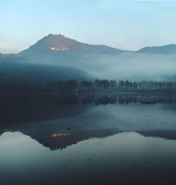 Scenic view of lake and mountains against sky