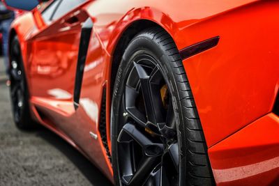 Red sports car parked on road