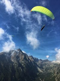 Aerial view of people paragliding against sky