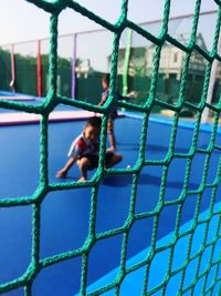 Boy seen through play equipment