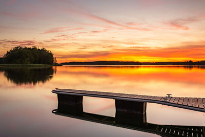 Scenic view of lake against orange sky