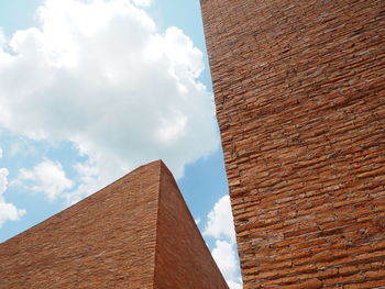 Low angle view of building against cloudy sky