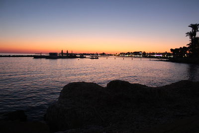 Scenic view of sea against clear sky at sunset