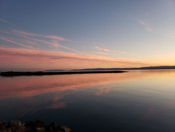 Scenic view of lake against sky during sunset