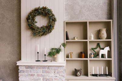 Christmas decor in the bedroom or living room with a wardrobe with open shelves and souvenirs