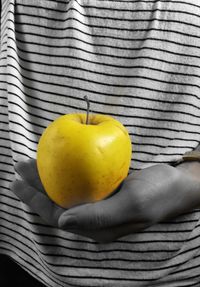 Close-up of hand holding apple