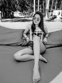 Portrait of a smiling young woman sitting outdoors