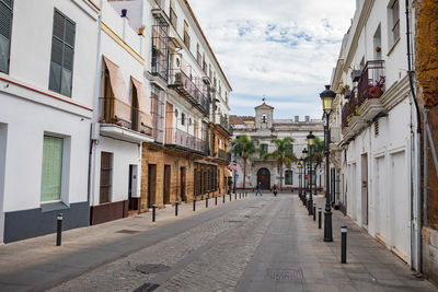 Empty alley amidst buildings in city