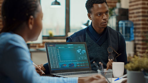 Young man using laptop at table