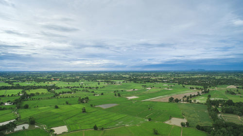 High angle view of green landscape against sky