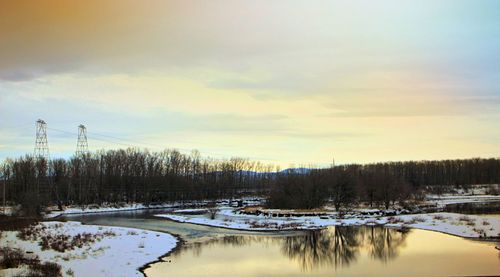 Scenic view of lake against sky during winter