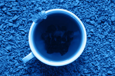 High angle view of coffee and blue cup