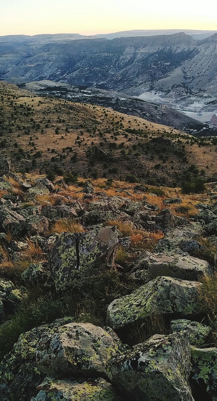 beauty in nature, tranquility, rock, scenics - nature, tranquil scene, no people, rock - object, solid, sky, nature, landscape, environment, mountain, non-urban scene, plant, day, high angle view, tree, idyllic, outdoors