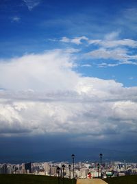 View of cityscape against cloudy sky