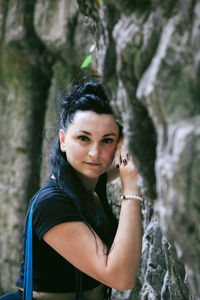 Portrait of young woman standing outdoors