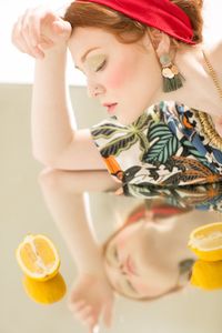 Portrait of woman holding drink on table