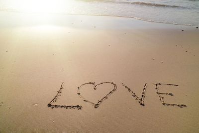 High angle view of text love written on sand. valentine's day.