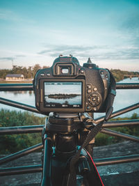 Close-up of camera against sky