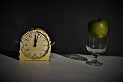 Close-up of clock on table