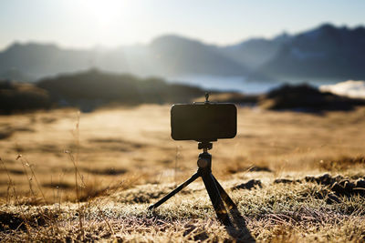 Close-up of camera against sky