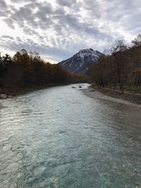 Scenic view of lake and mountains against sky