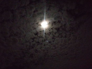 Low angle view of illuminated lights against sky at night