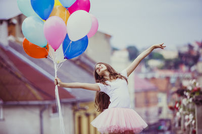 Rear view of woman with balloons at outdoors