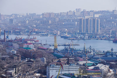 High angle view of buildings by sea against sky