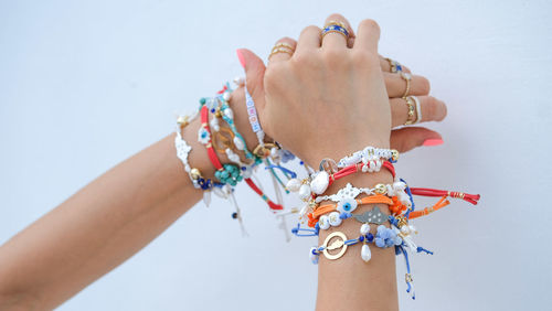 Close-up of woman hand holding multi colored umbrellas