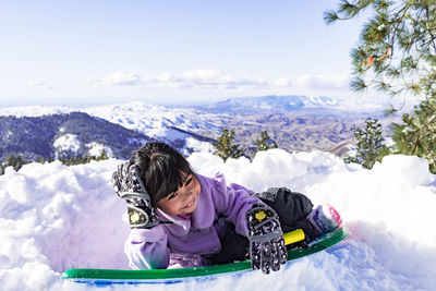 Rear view of woman on snowcapped mountains during winter