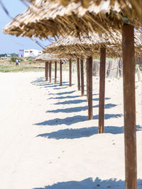Wooden posts on beach against building