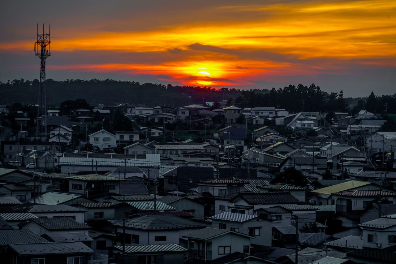 sky, architecture, sunset, built structure, city, building exterior, building, cityscape, cloud, nature, orange color, horizon, no people, residential district, sun, landscape, environment, afterglow, travel destinations, high angle view, outdoors, dusk, house, roof, scenics - nature, dramatic sky, skyline, beauty in nature, town, evening, city life, silhouette, technology, tower, urban skyline