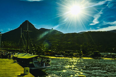 Scenic view of lake against bright sun