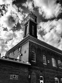 Low angle view of buildings against cloudy sky