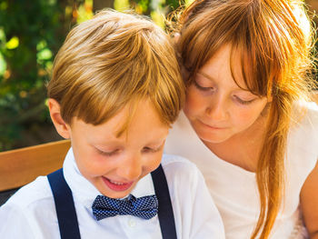 Siblings sitting outdoors